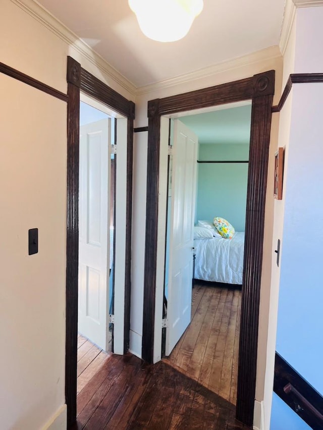 corridor featuring wood-type flooring and crown molding