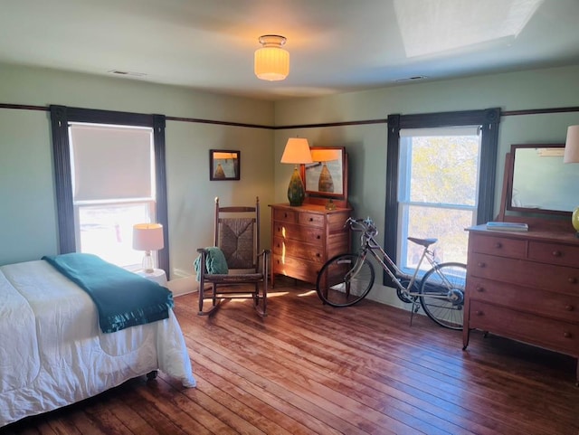 bedroom with visible vents and wood-type flooring