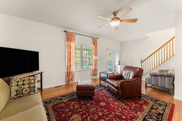 9333 Red Bank Rd, Nassawadox, VA 23413 - living area featuring wood finished floors, a ceiling fan, baseboards, and stairs