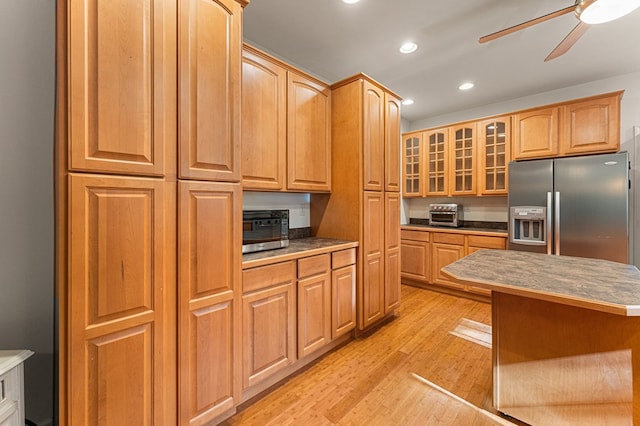 9333 Red Bank Rd, Nassawadox, VA 23413 - kitchen with stainless steel refrigerator with ice dispenser, a ceiling fan, glass insert cabinets, light wood-type flooring, and recessed lighting