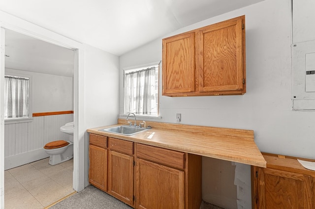 9333 Red Bank Rd, Nassawadox, VA 23413 - kitchen with a sink, vaulted ceiling, light countertops, light floors, and brown cabinets