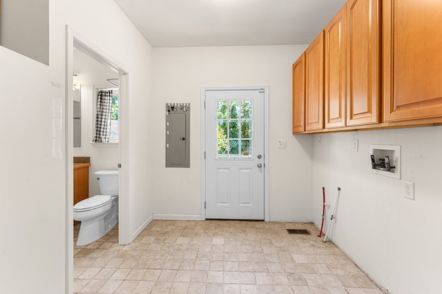 9333 Red Bank Rd, Nassawadox, VA 23413 - laundry room with cabinet space, electric panel, washer hookup, and light stone finish floors