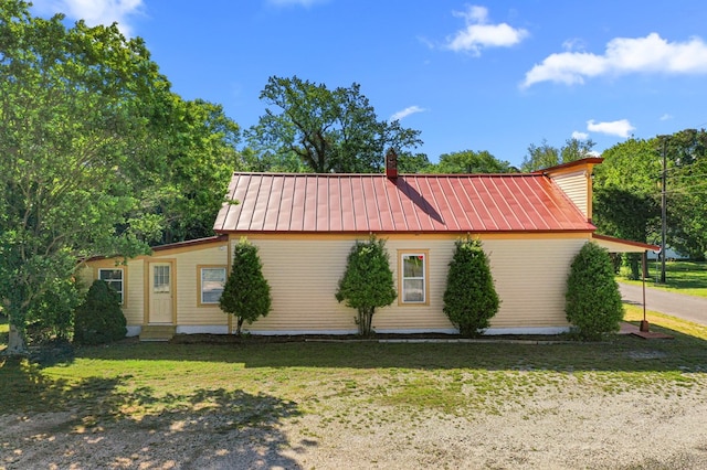 9333 Red Bank Rd, Nassawadox, VA 23413 - view of side of property with a yard, metal roof, entry steps, and a chimney