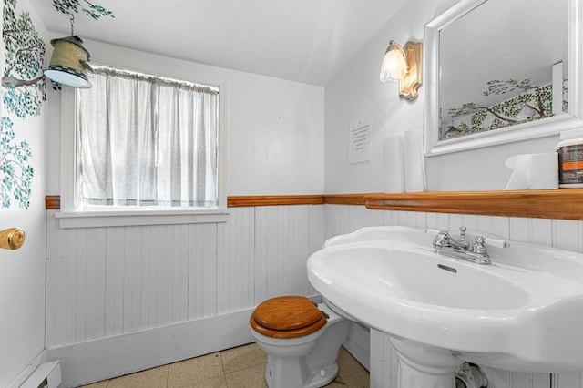 9333 Red Bank Rd, Nassawadox, VA 23413 - half bath with a wainscoted wall, toilet, baseboard heating, a sink, and wood walls