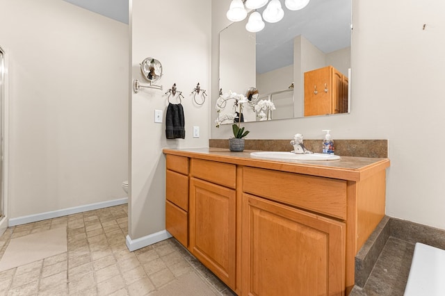 9333 Red Bank Rd, Nassawadox, VA 23413 - full bath with a stall shower, vanity, toilet, baseboards, and a chandelier
