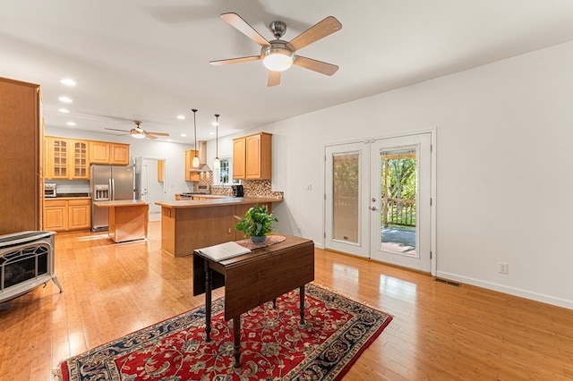 9333 Red Bank Rd, Nassawadox, VA 23413 - living room with ceiling fan, light wood-style floors, recessed lighting, baseboards, and a wood stove