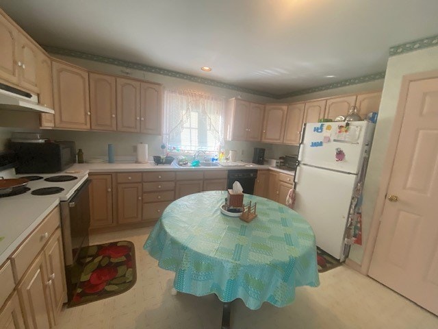 kitchen with white appliances, sink, and light brown cabinetry