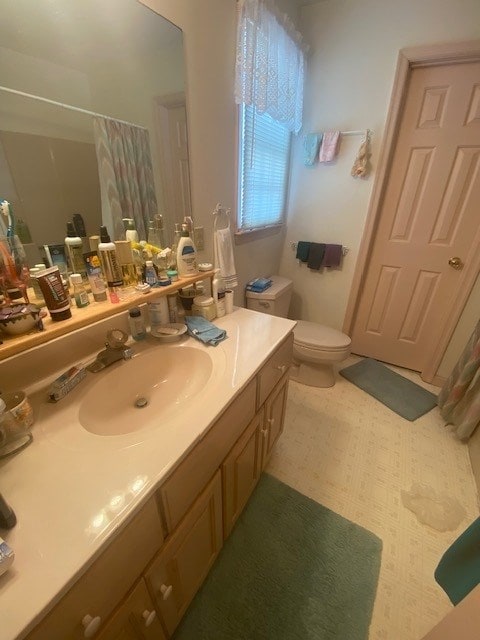 bathroom with vanity, toilet, and walk in shower