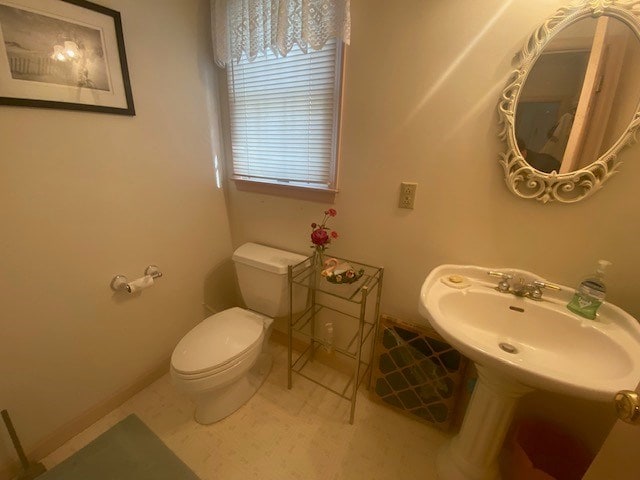 bathroom featuring toilet and tile patterned floors