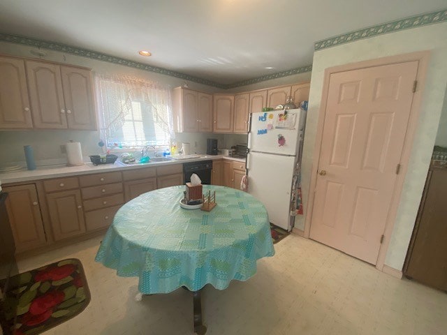 kitchen featuring white refrigerator, sink, black dishwasher, and light brown cabinetry