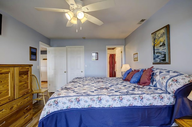 bedroom featuring ceiling fan, wood-type flooring, and white fridge