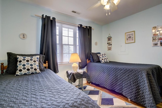 bedroom with hardwood / wood-style floors and ceiling fan