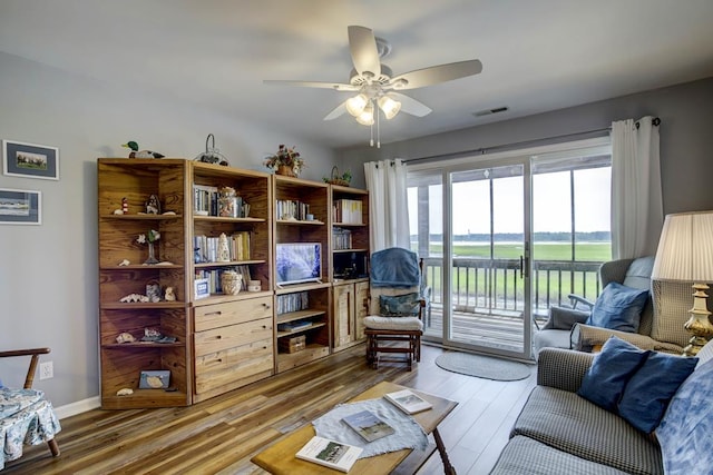 living room with ceiling fan and hardwood / wood-style floors