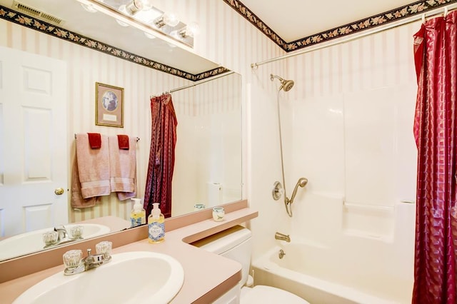 full bathroom featuring vanity, shower / bath combination with curtain, and toilet