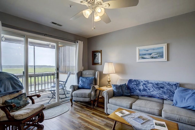 living room with ceiling fan and hardwood / wood-style floors