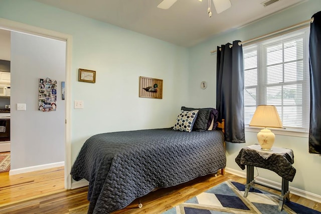 bedroom with wood-type flooring and ceiling fan