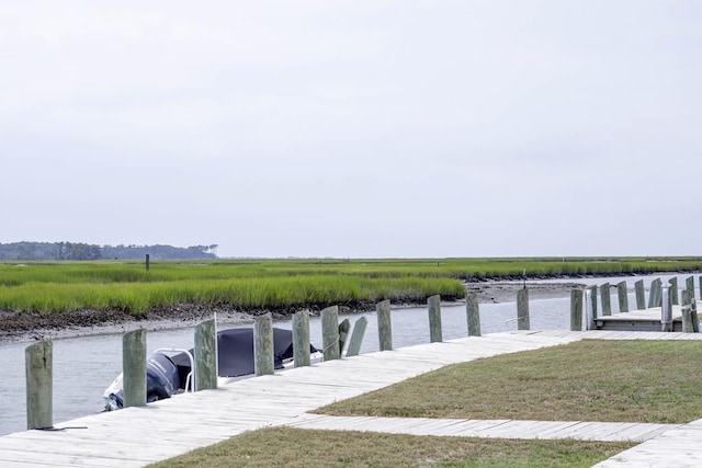 dock area featuring a water view and a yard