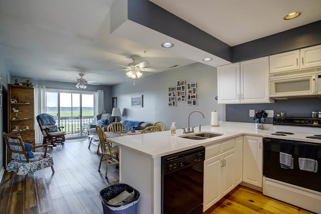 kitchen with white cabinetry, black dishwasher, electric range, and kitchen peninsula