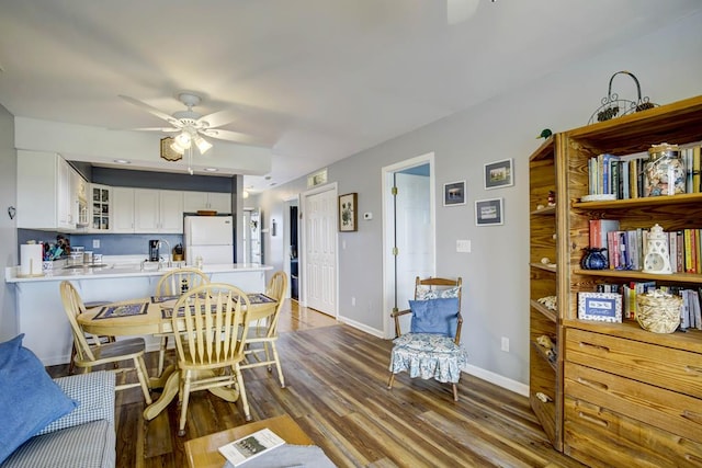 dining room with ceiling fan and wood-type flooring