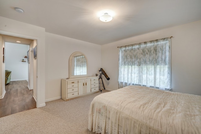 carpeted bedroom featuring baseboards