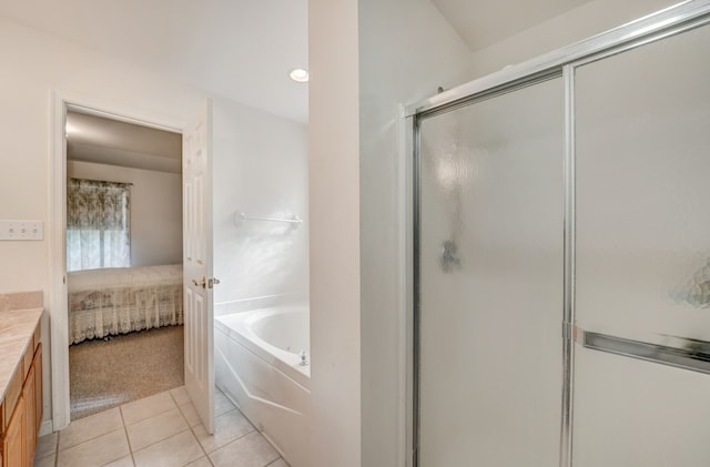 bathroom featuring a garden tub, vanity, tile patterned flooring, ensuite bathroom, and a shower stall