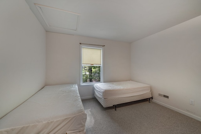 carpeted bedroom featuring baseboards and visible vents