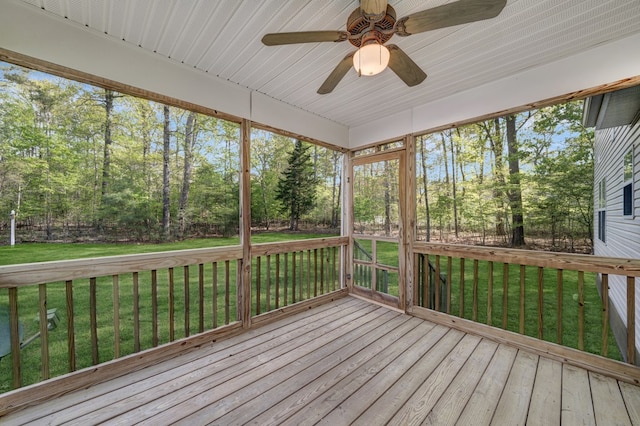 unfurnished sunroom featuring ceiling fan