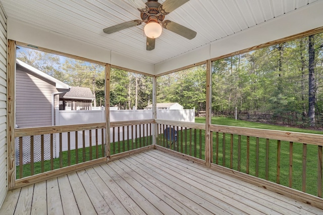 unfurnished sunroom with ceiling fan
