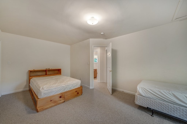 bedroom featuring light colored carpet and baseboards