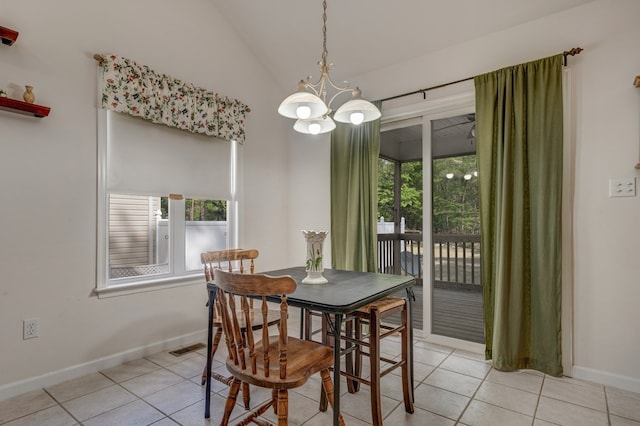 dining space with light tile patterned floors, baseboards, an inviting chandelier, and lofted ceiling