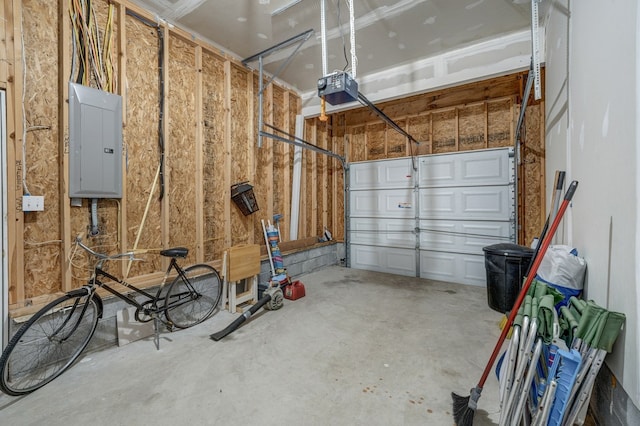 garage with a garage door opener and electric panel