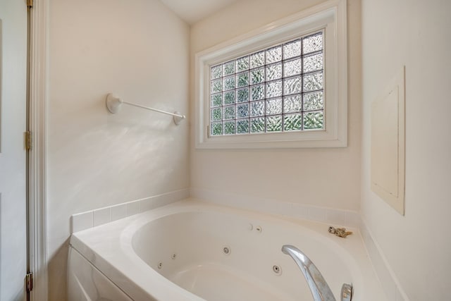 bathroom featuring a tub with jets