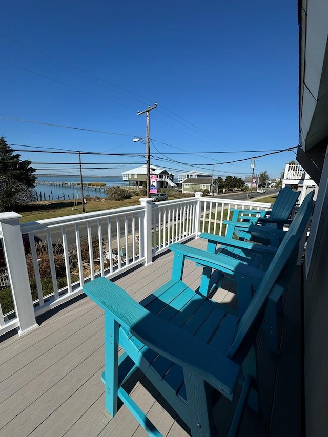 wooden terrace featuring a water view