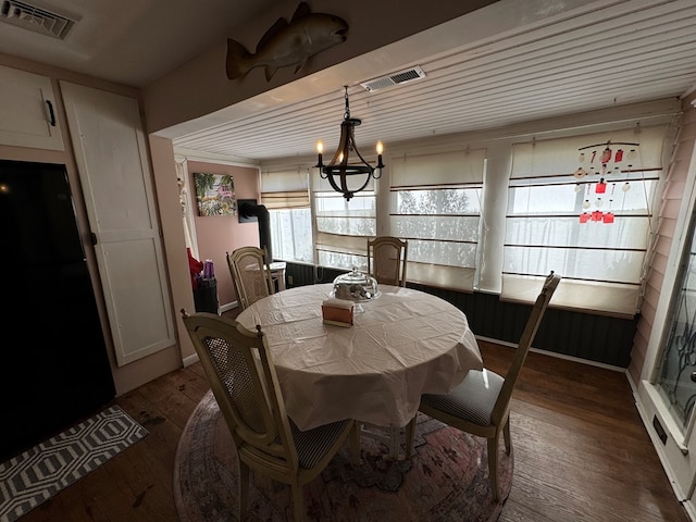 dining room with a notable chandelier and dark hardwood / wood-style flooring