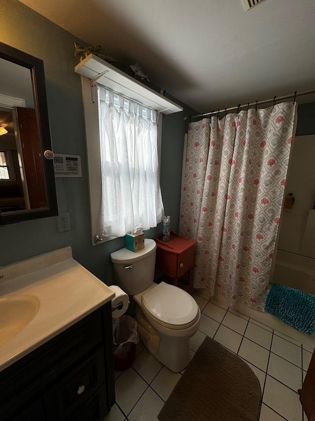 full bathroom featuring tile patterned flooring, vanity, toilet, and shower / tub combo with curtain