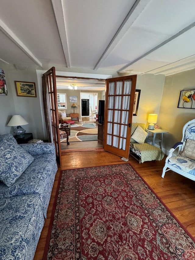 living room with beam ceiling and wood-type flooring