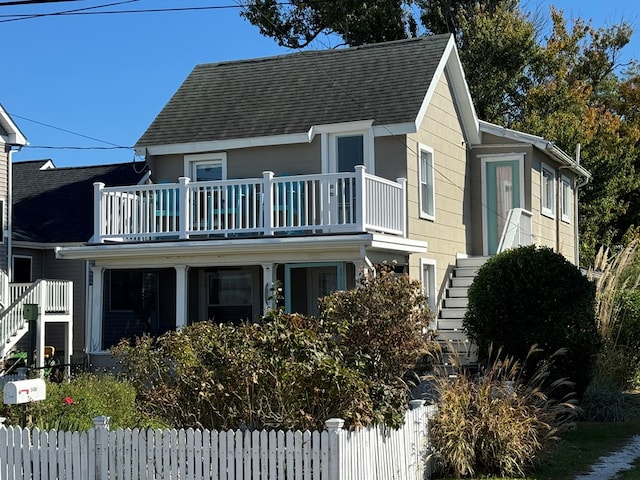 view of front of home featuring a balcony