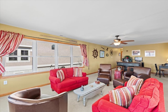 living room with visible vents, carpet, baseboards, and ceiling fan