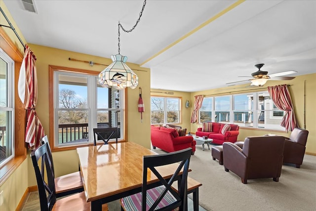 dining area featuring visible vents, baseboards, carpet flooring, and a ceiling fan