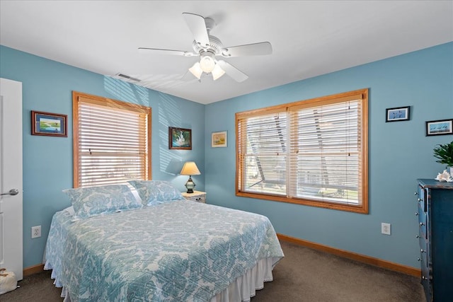 bedroom featuring visible vents, multiple windows, and baseboards