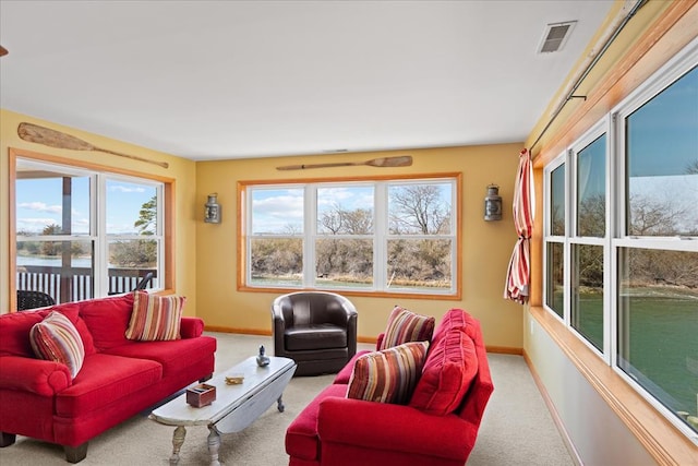 living room featuring carpet flooring, baseboards, and visible vents