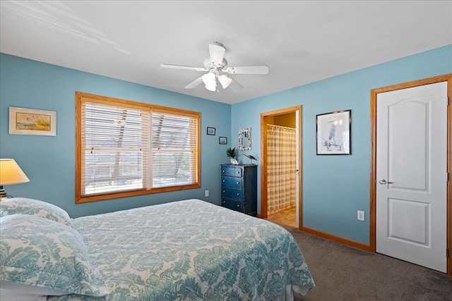 carpeted bedroom featuring connected bathroom, a ceiling fan, and baseboards