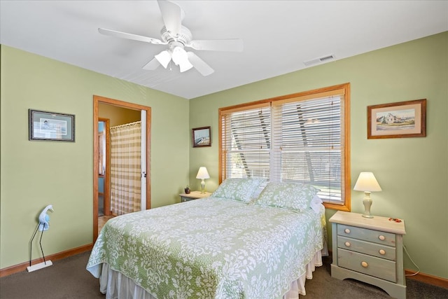 carpeted bedroom with visible vents, baseboards, and a ceiling fan