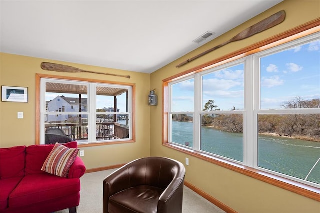 living area featuring carpet flooring, baseboards, and visible vents