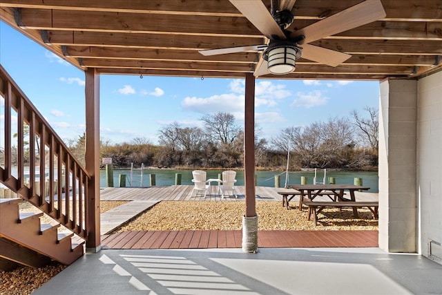 view of patio featuring a ceiling fan and a dock