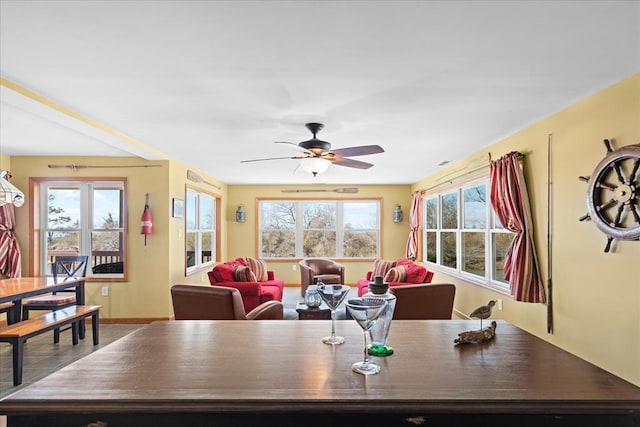 dining space featuring baseboards, plenty of natural light, and ceiling fan