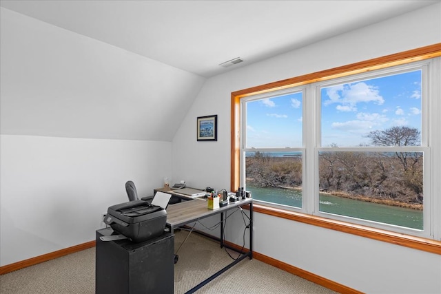 office space featuring lofted ceiling, baseboards, a water view, and carpet floors