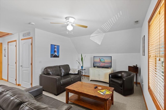 carpeted living area with visible vents, baseboards, ceiling fan, and vaulted ceiling