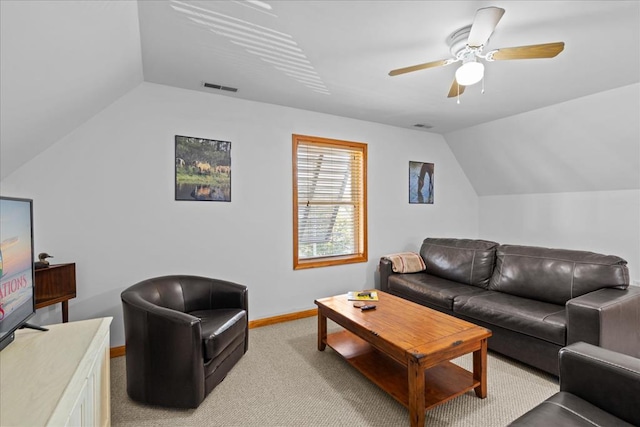 living room featuring visible vents, lofted ceiling, a ceiling fan, baseboards, and light colored carpet