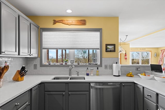 kitchen with a sink, decorative backsplash, dishwasher, and gray cabinets